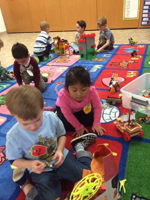 Children in a preschool setting playing with toys